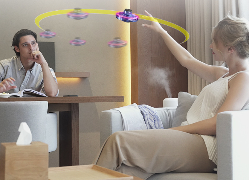 Light-up spinner ball flying back to a hand