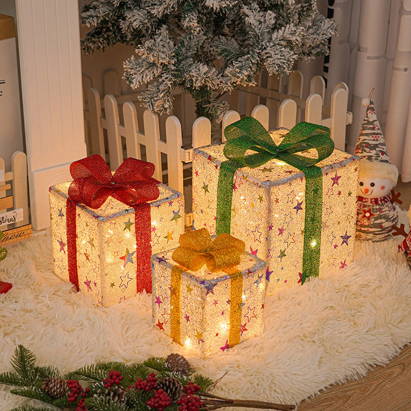 Three light up Christmas gift boxes with bows