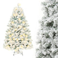 Snow-flocked Christmas tree with warm-white lights