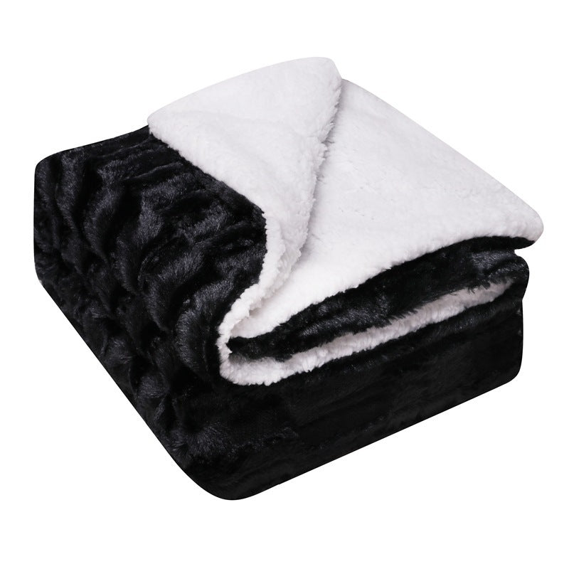 Thick sherpa blanket folded on a sofa