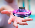 Light-up spinner ball flying back to a hand