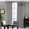 Grey chenille blackout curtain at window