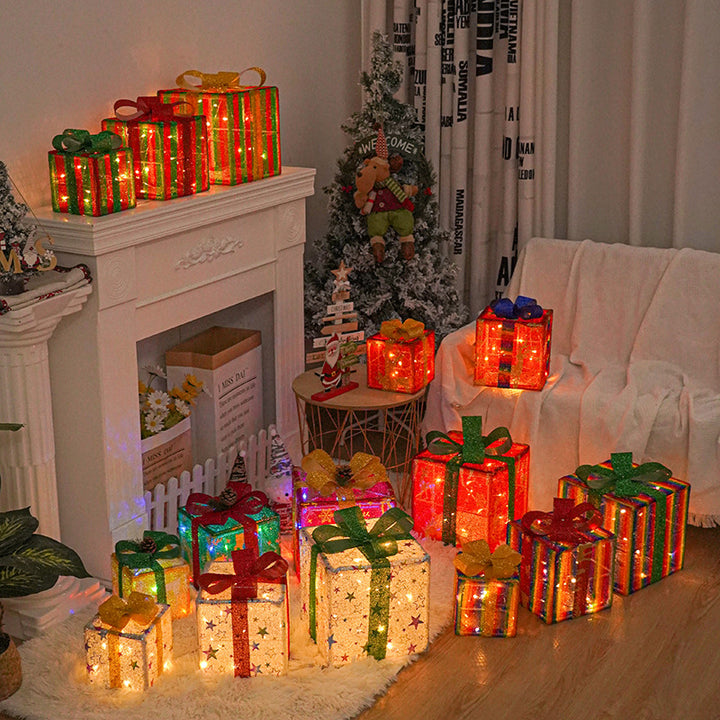 Three light up Christmas gift boxes with bows