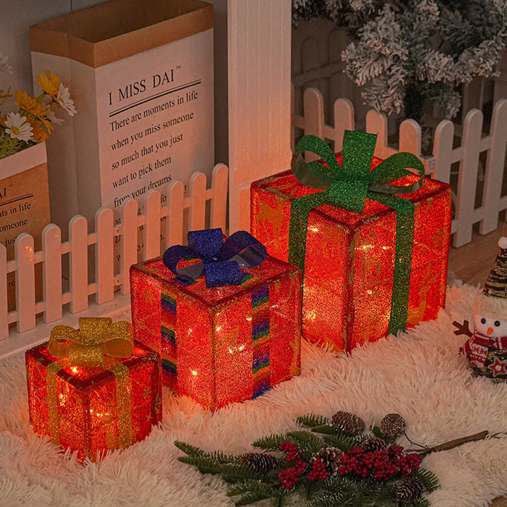 Three light up Christmas gift boxes with bows