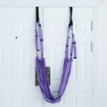 Yoga stretch strap hanging from a door